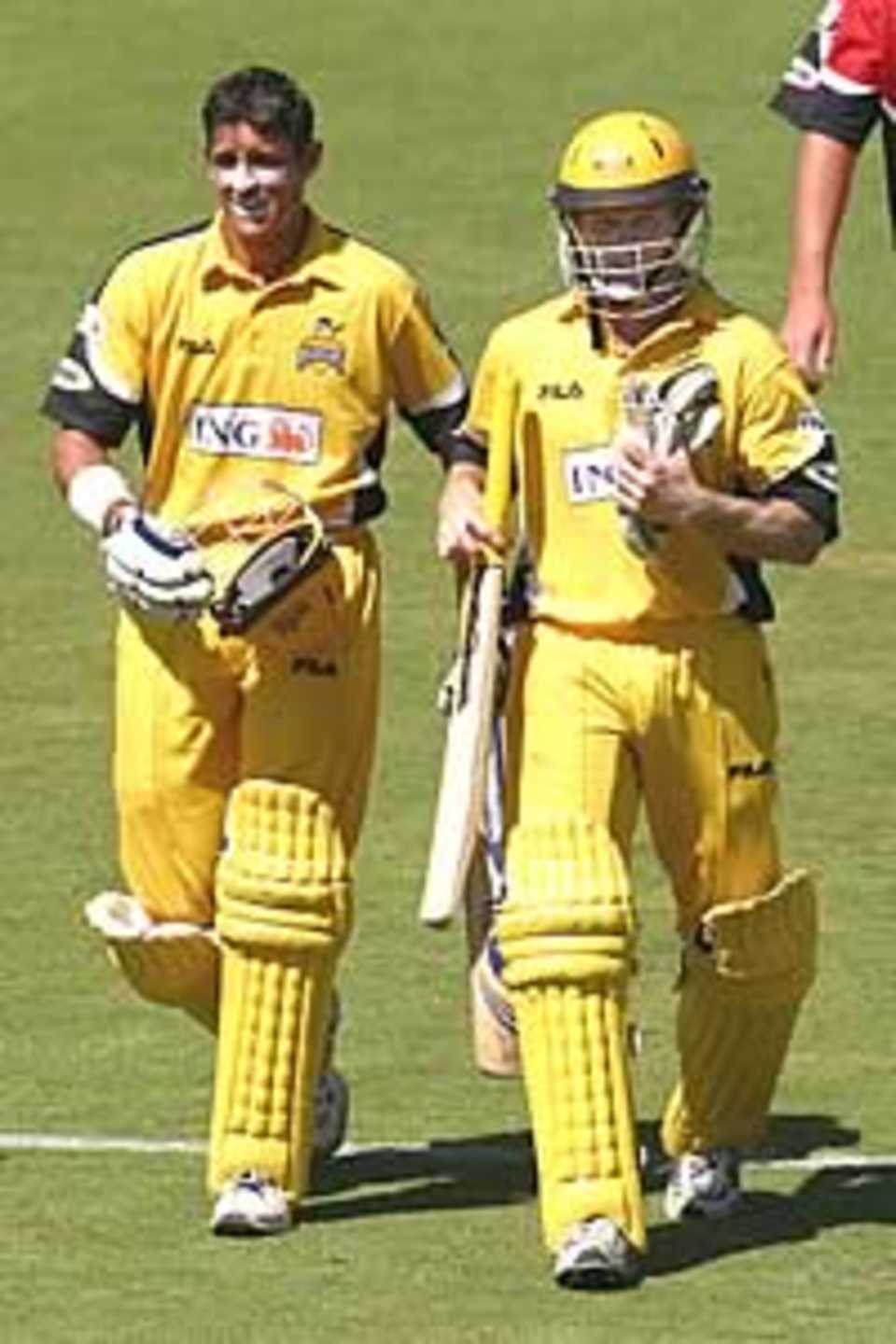 ADELAIDE - FEBRUARY 1: Michael Hussey of the Warriors (L) and Chris Rogers leave the field after the Warriors defeated the Redbacks by eight wickets in the ING Cup match between the Southern Redbacks and the Western Warriors played at Adelaide Oval in Adelaide, Australia on February 1, 2003.