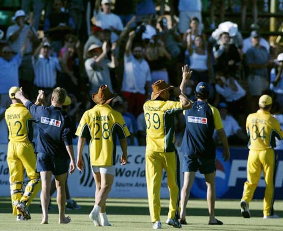 Australian team members wave to members of the crowd as they walk around after their victory