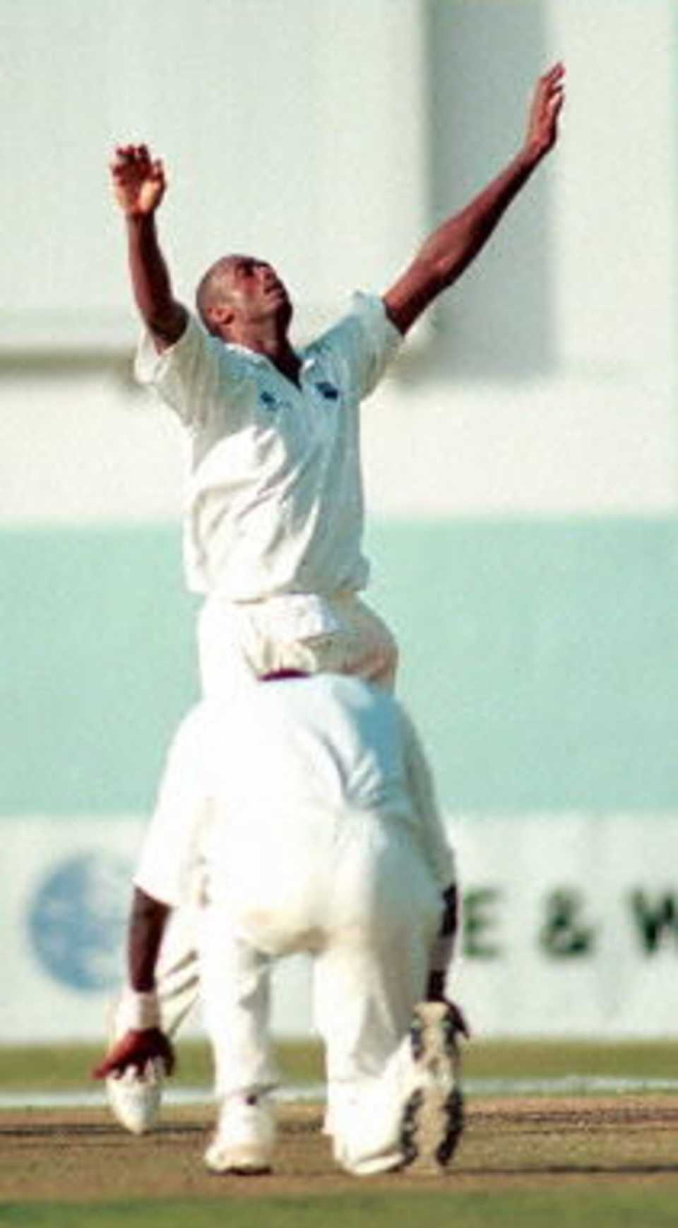 West Indies fast bowler Courtney Walsh celebrates after taking his 435th wicket against Zimbabwe 27 March, 2000 in Kingston, Jamaica. Walsh broke the record held by India's Kapil Dev for most number of wickets