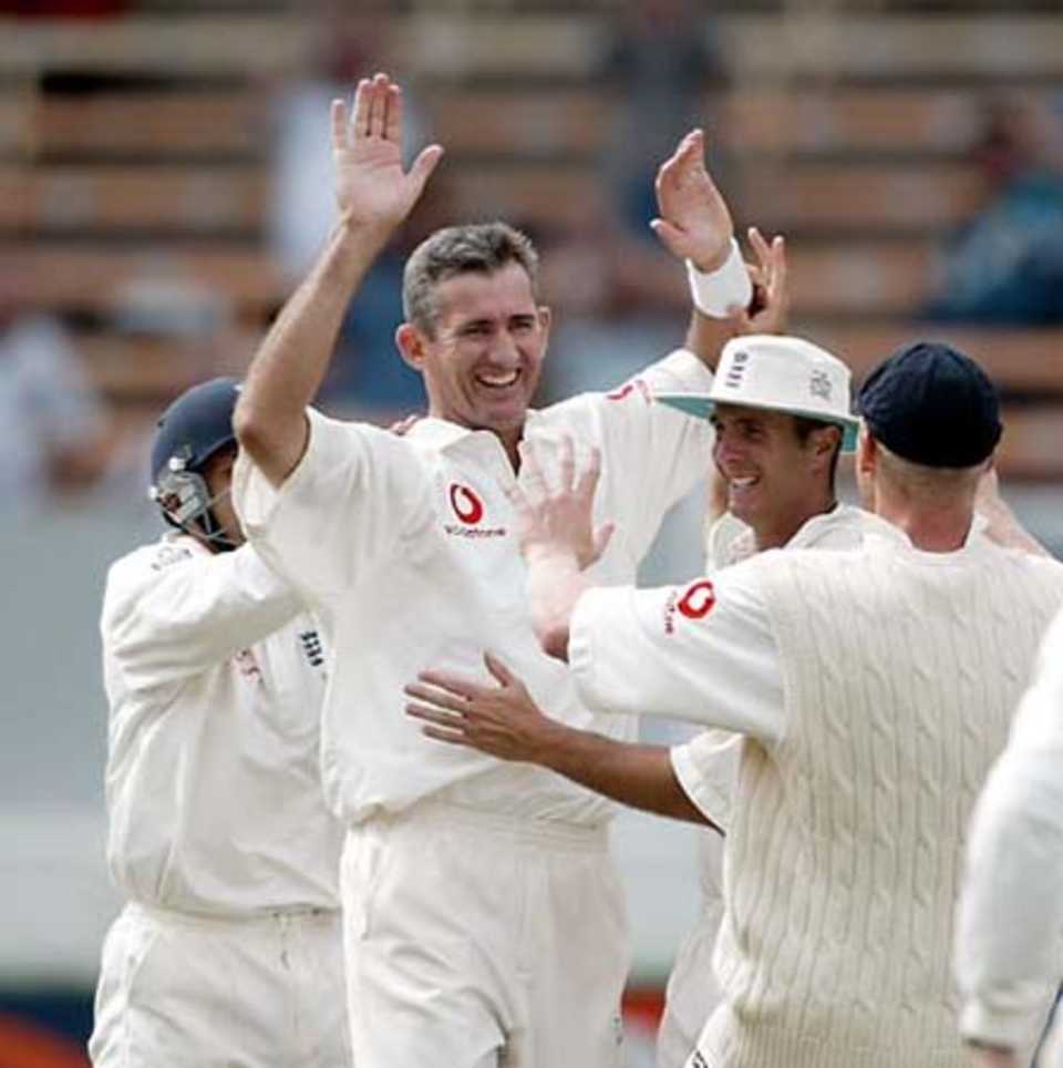 England bowler Andy Caddick is congratulated by team-mates after dismissing New Zealand batsman Adam Parore, bowled for one. From left, Mark Ramprakash (obscured), Caddick, Michael Vaughan and Andrew Flintoff. 1st Test: New Zealand v England at Jade Stadium, Christchurch, 13-17 March 2002 (16 March 2002).