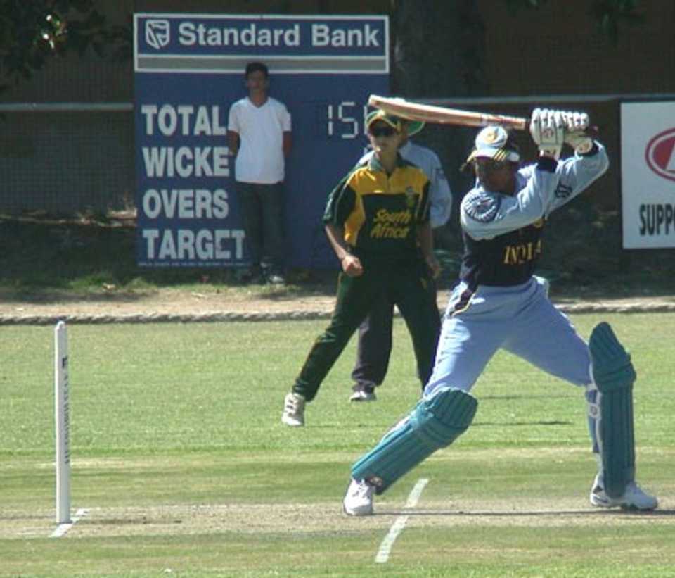 India's Jhulan Goswani cuts a delivery to the thirdman boundary while SA fielder Sunette Viljoen looks on.