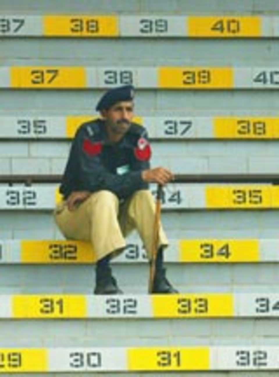 A lone policeman watches in the stands, Pakistan A v Indians, Lahore, March 11, 2004