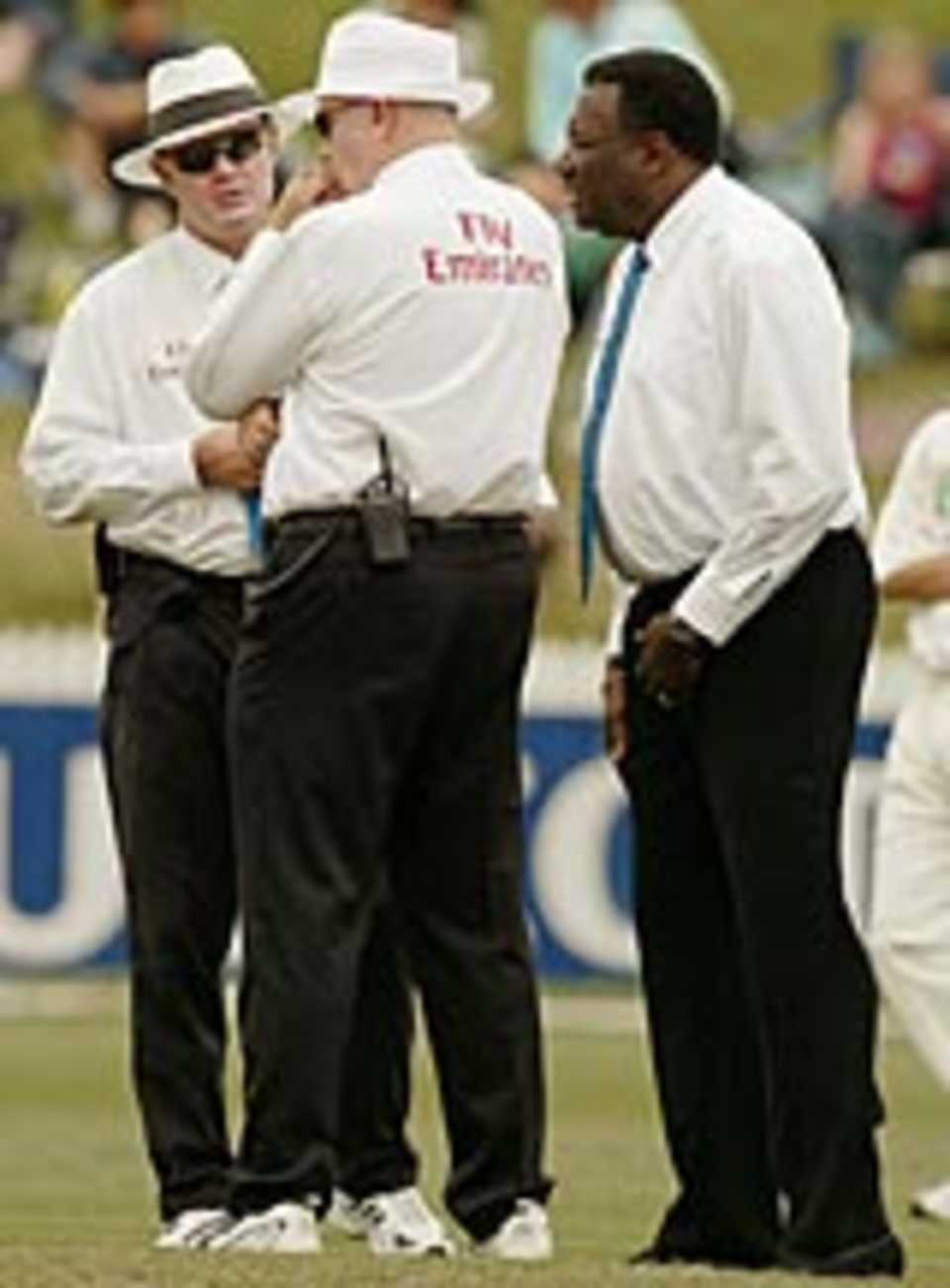 Clive Lloyd discusses the state of the pitch with umpires Russel Tiffin and Steve Davis