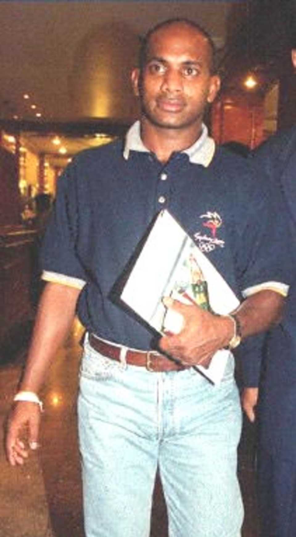 Sanath Jayasuriya, Sri Lankan skipper and vice-captain of the Asia XI, walks in a hotel lobby upon his arrival in Dhaka, 06 April 2000 along with three compatriots to play in Saturday's one-day limited over Cricket Cup match against the World XI. The International Cricket Council (ICC) is organizing the event in Dhaka as part of its Cricket Week. Wasim Akram of Pakistan and Mark Waugh of Australia are to captain respectively the Asia XI and World XI.