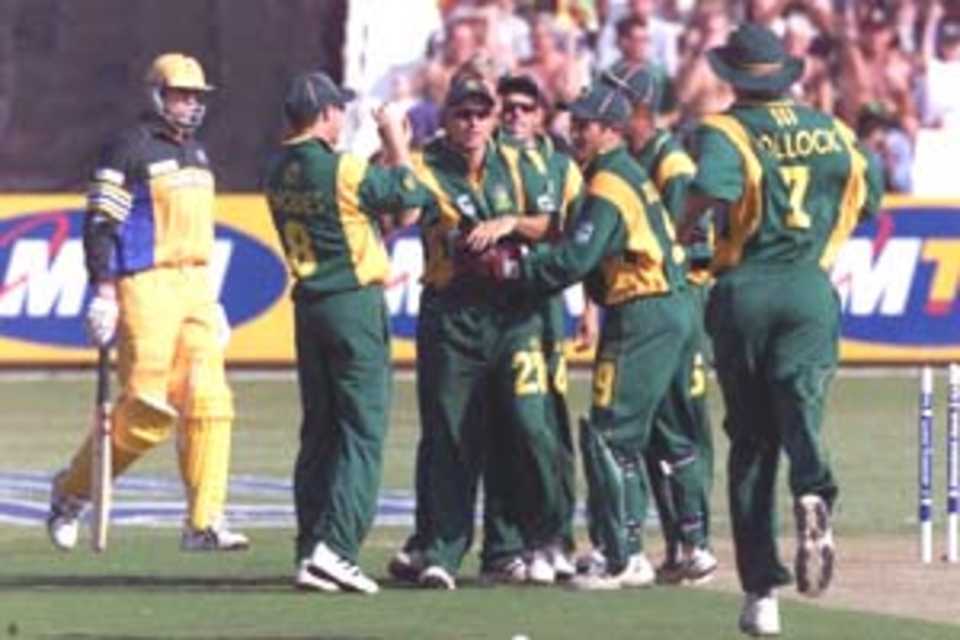 12 Apr 2000: Hershell Gibbs of South Africa is congratulated by his team-mates after running out Matthew Hayden of Australia during the first game of the One Day International Series between South Africa and Australia at Kingsmead, Durban, South Africa.