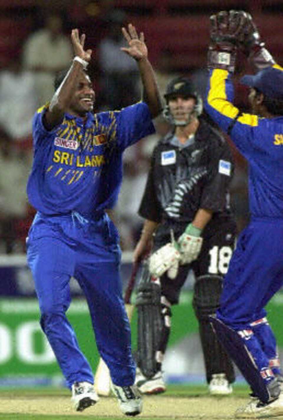 Sanath Jayasuriya celebrates his second wicket with Kumar Sangakkara after the exit of Jacob Oram, ODI2, New Zealand v Sri Lanka, Sharjah, 10 April 2001
