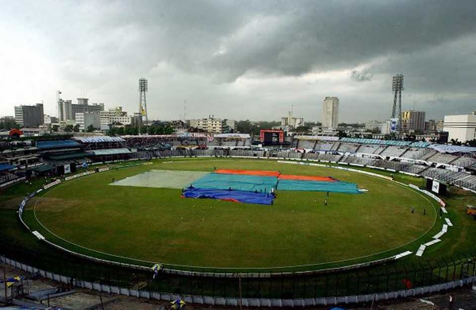 Black clouds hang over Banghabandhu nation stadium in Dhaka as the pitch is covered with plastic 20 April 2003. South African and India are to play the final match of the TVS tri-nation cricket tournament, but heavy rain stopped the match before it could start