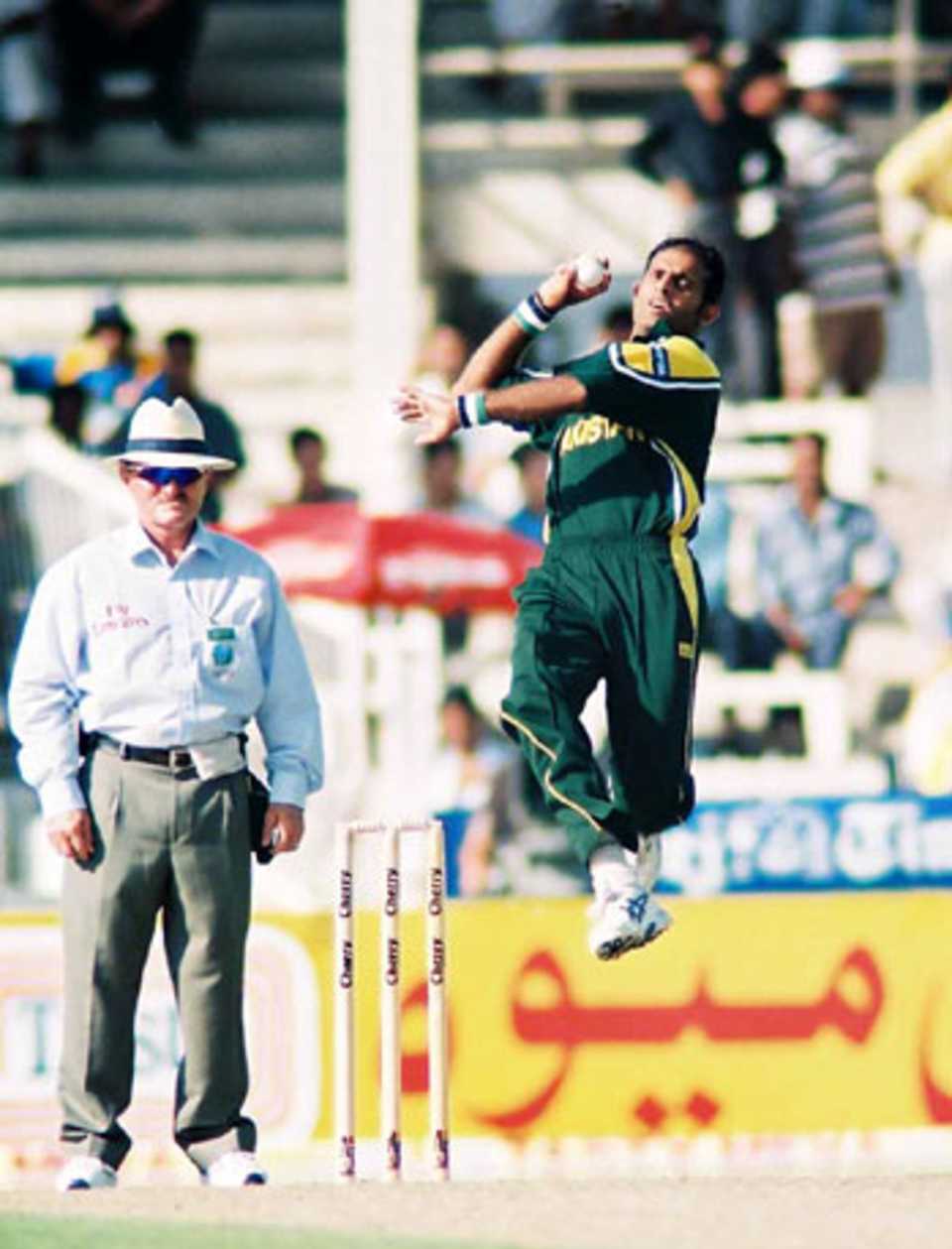 Naved-ul-Hasan in his follow through, 2nd Match: Pakistan v Sri Lanka, Cherry Blossom Sharjah Cup, 4 Apr 2003