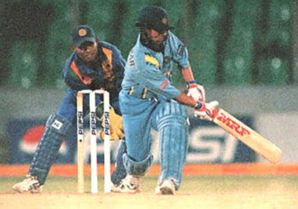 Indian super batsman Sachin Tendulkar try to sweep a ball during the four-nation Asia Cup limited-overs tournament against defending champions Sri Lanka at the Bangabandhu national stadium in Dhaka. Tendulkar playing a superb innings scored 93 runs off 95 balls before being caught by Jayasuriya off a ball from Weeraratne. Behind him is Sri Lankan wicketkeeper Kaluwitharana. India earlier restricted Sri Lanka 276-8. Asia Cup, 1999/00, 3rd Match, India v Sri Lanka, Bangabandhu National Stadium, Dhaka. 1 June 2000.