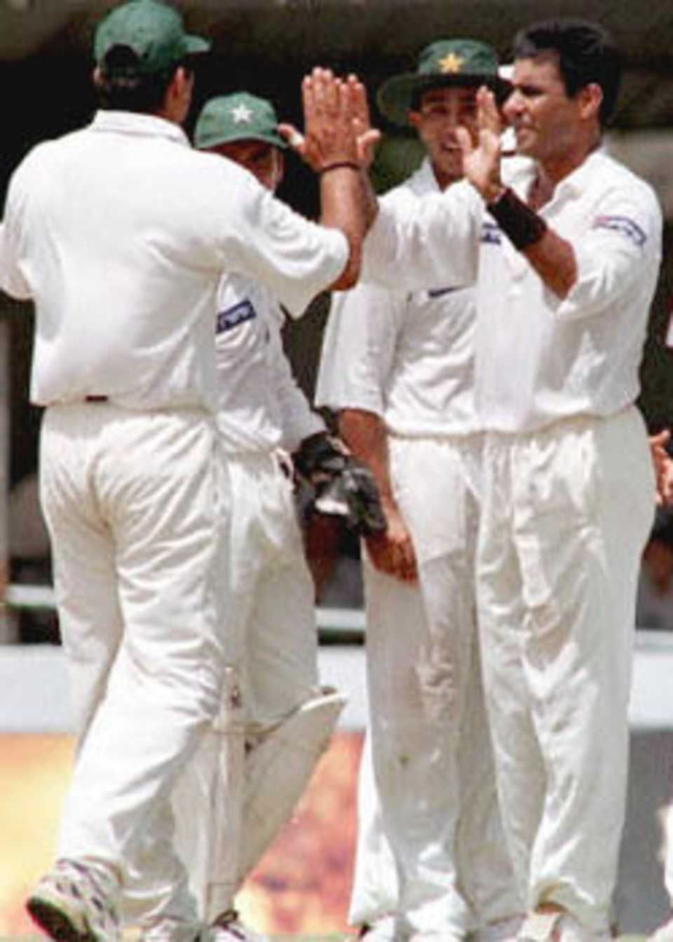 Pakistani bowler Waqar Younis (R) celebrates with teammates during the fourth day of the second Test against Sri Lanka played at Galle international cricket stadium. Pakistan won the match by an innings and 163 runs to take an unbeatable 2-0 lead in the three match series. Pakistan in Sri Lanka, 1999/00, 2nd Test, Sri Lanka v Pakistan, Galle International Stadium, 21-25 June 2000 (Day 4).
