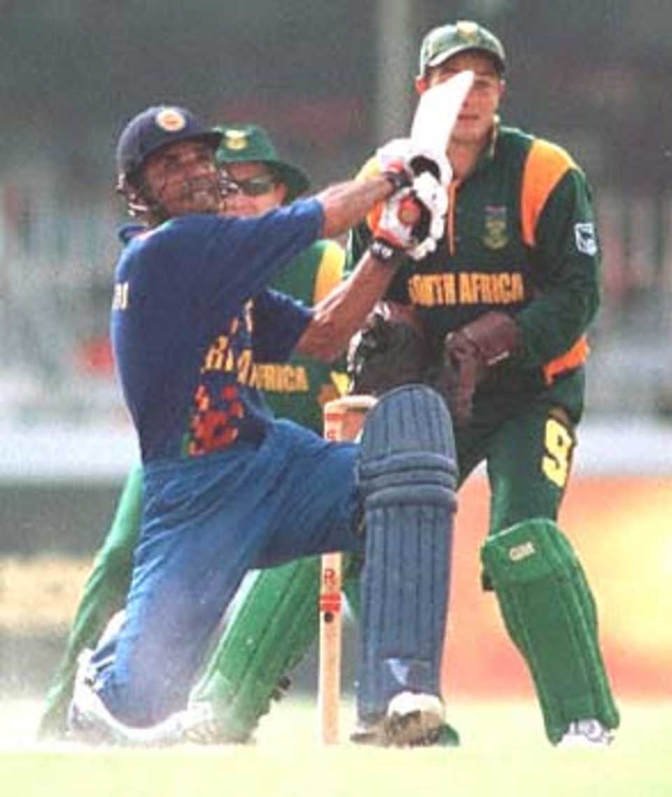 Sri Lankan batsman Marvan Atapattu lifts a ball in his innings of 44 not out in the match against South Africa in the Singer Triangular series in the Sri Lankan capital of Colombo as wicket keeper Mark Boucher looks on. Sri Lanka won the match by eight wickets.