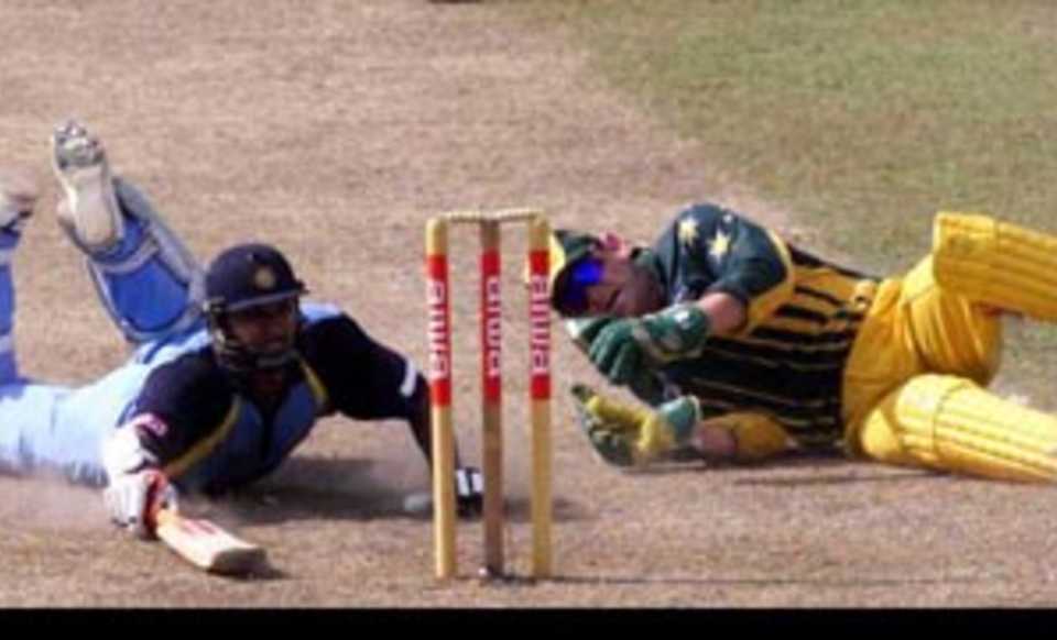 28th August 1999: Adam Gilchrist of Australia falls over in an attempt to run out Robin Singh of India, during the match between India and Australia at Singhalese Stadium, Colombo, Sri Lanka.