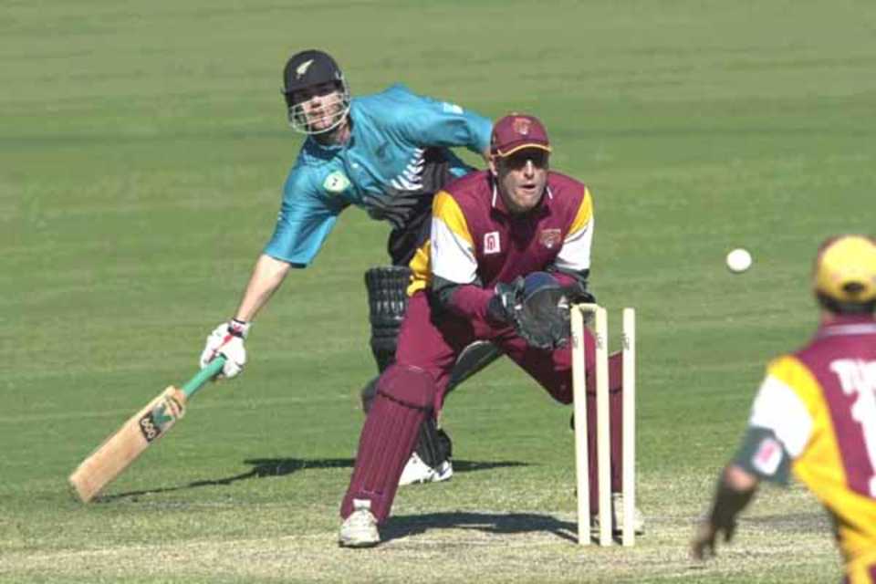 15 Aug 2000: Adam Parore of New Zealand just makes it back to his crease despite the efforts of Wade Seccombe of Queensland during the New Zealand versus Queensland practice match at Allan Border Field in Brisbane, Australia. Queensland won the game by 23 runs.