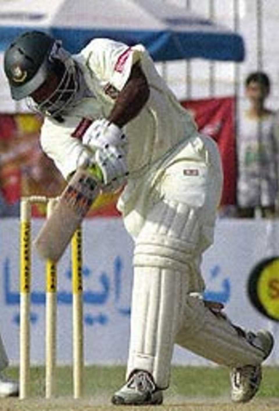 Javed Omar drives en route to his century against Pakistan at Peshawar