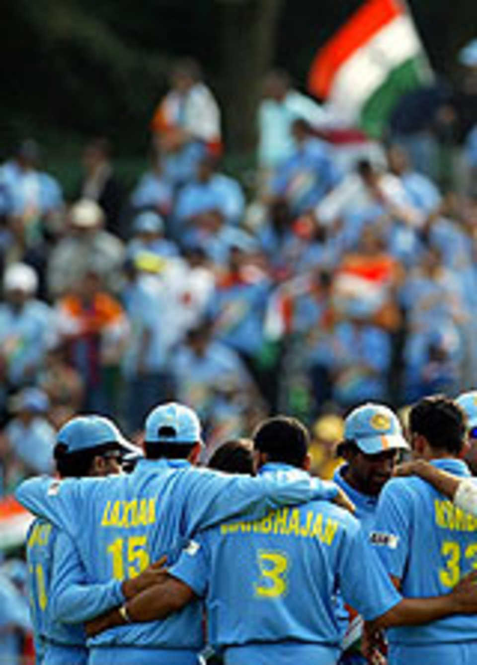 The Indian team in a huddle after dismissing an Australian batsman