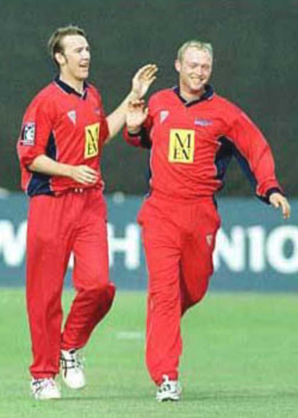 Chris Schofield and Gary Keedy celebrate after the former effected a run out
