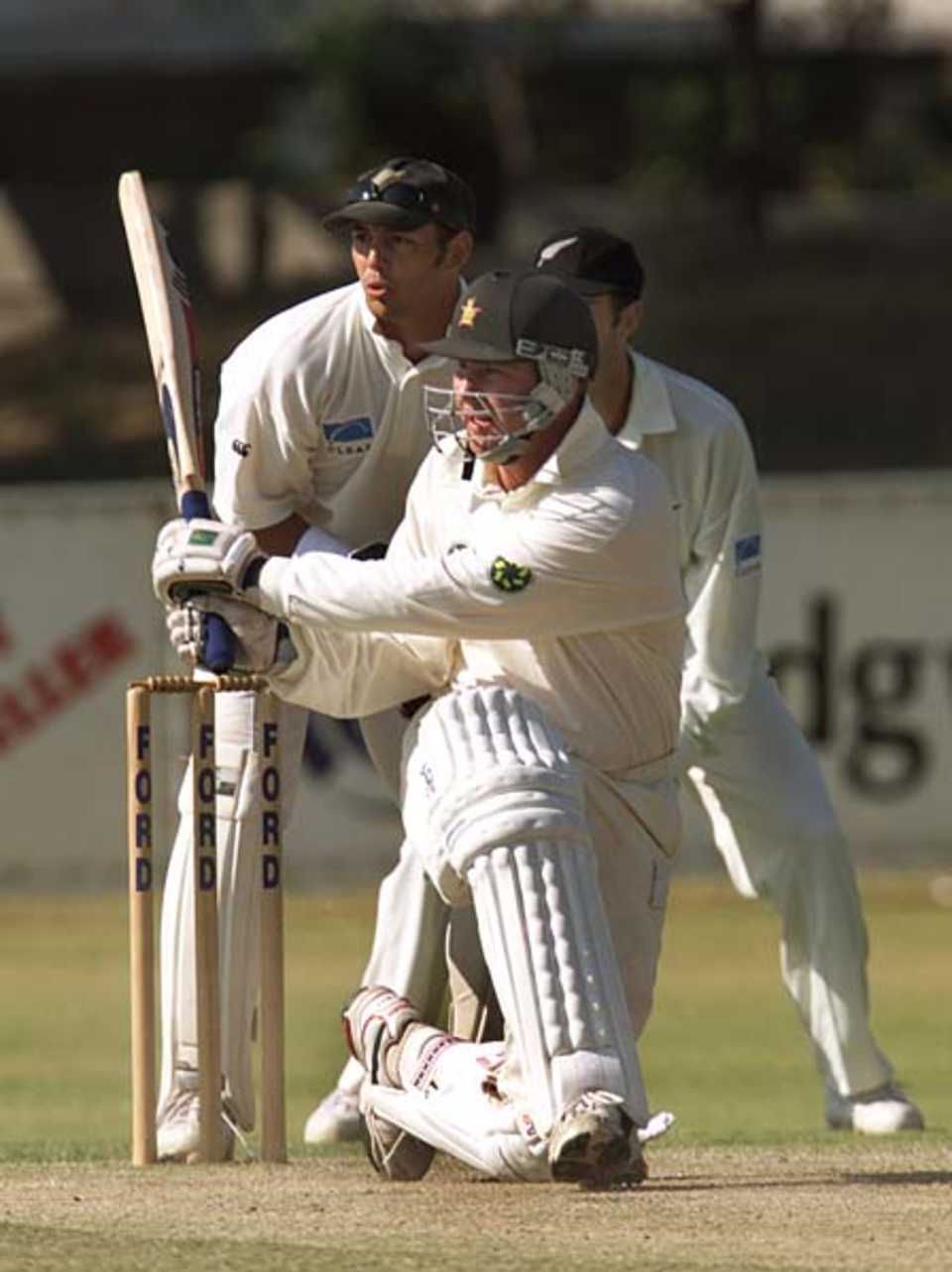 Alistair Campbell sweeps in the second innings, Zimbabwe v New Zealand, 1st Test, 16 Sep 2000
