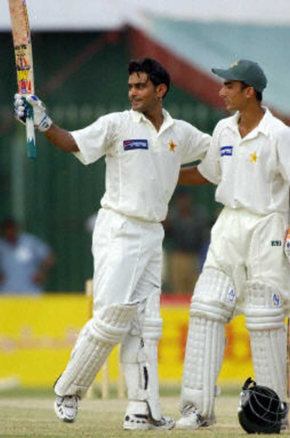 Mohammad Hafeez (L) acknowledges the crowd after his first Test century while teammate Yasir Hameed looks on during the fourth day of the second Test between Pakistan and Bangladesh in Peshawar, 30 August 2003.