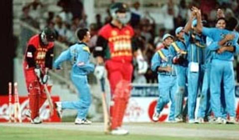 Zaheer Khan congratulated by his teammates after dismissing Campbell. Coca-Cola Champions Trophy 2000/01, 3rd Match, India v Zimbabwe, Sharjah C.A. Stadium, 22 October 2000