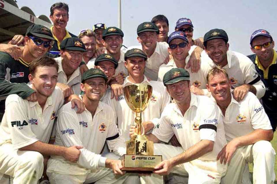 The Australian team poses with the cup after winning the Sharjah test against Pakistan at the Sharjah cricket stadium on October 22, 2002. Australia won the test by an innings and 20 runs.