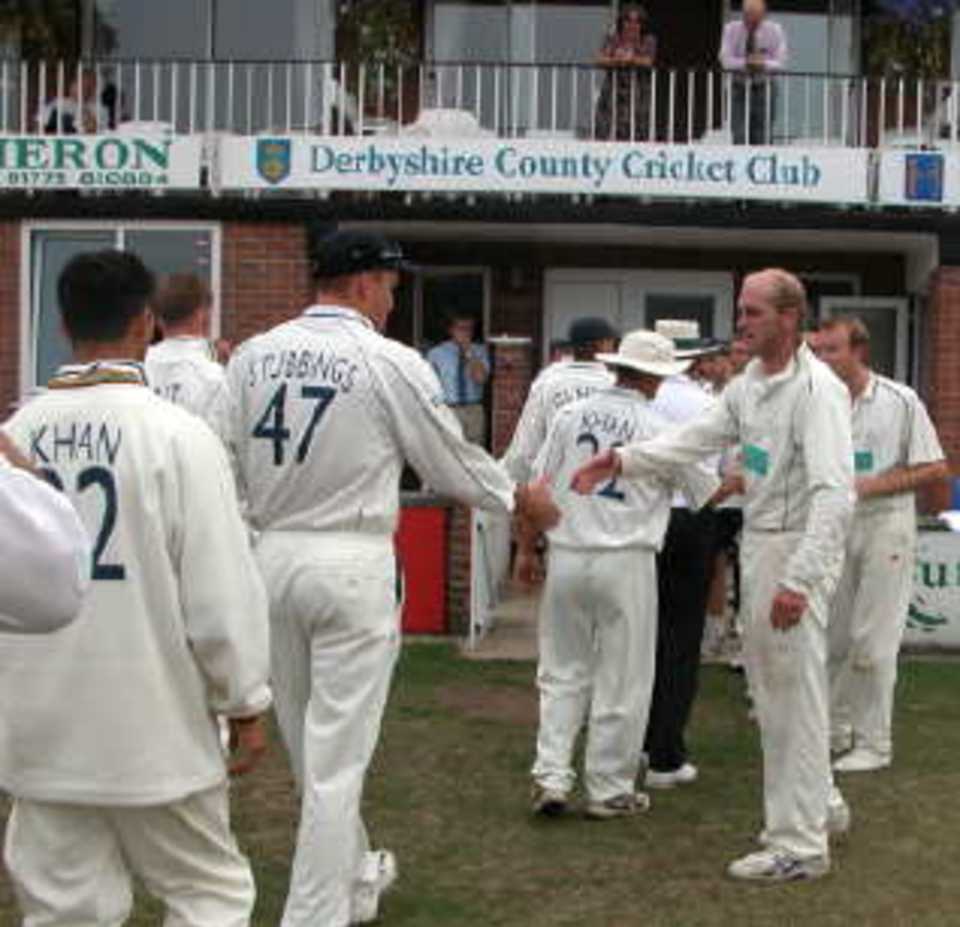 Players congratulate each other at the end of the last Championship match of the season at Derby.