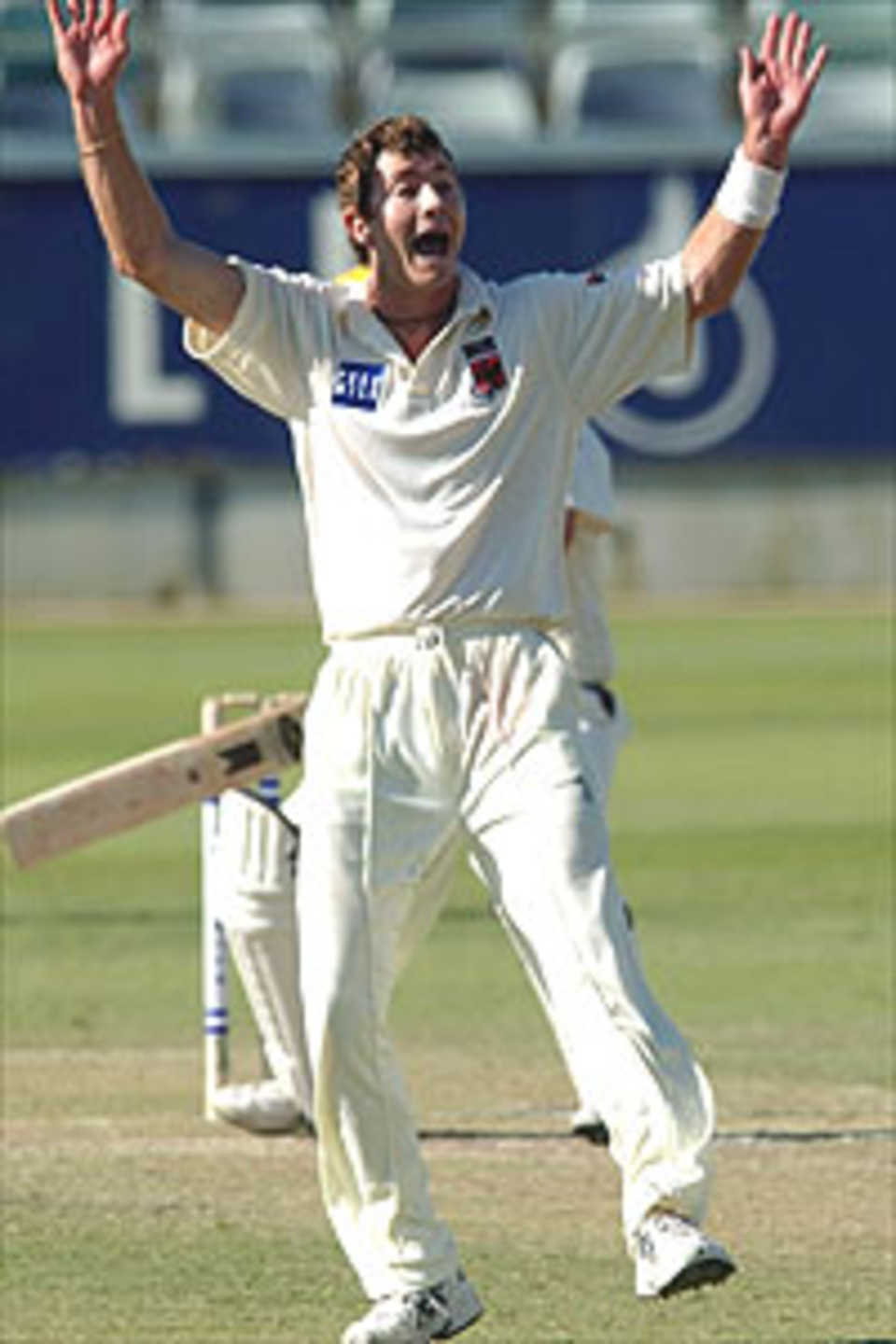 Mark Cleary for the Redbacks celebrates claiming the wicket of Murray Goodwin for the Warriors during the second day of the Pura Cup match between Retravision Warriors and South Australian Redbacks at the WACA October 21, 2003 in Perth, Australia.
