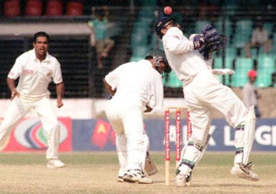 Indian wicketkipper Saba Karim (R) tries to catch a ball off Sunil Joshi (L) hit by Bangladeshi skipper Naimur Rhaman (C) 13 November 2000 at the Bangabandhu National Stadium in downtown Dhaka. India won by nine wickets by the end of fourth day's play of Bangladesh's inaugural five day test match.