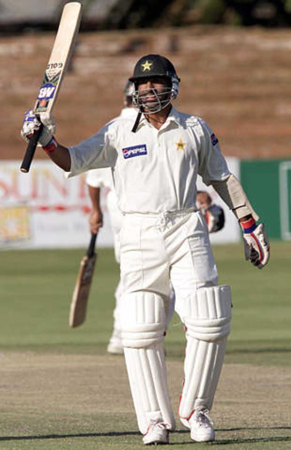 Pakistan batsman Yousuf Youhana celebrates reaching his century against Zimbabwe November 17, 2002. Youhana was undefeated on 116 runs with Pakistan on 295 runs for 5 wickets at stumps on day two of the second Test match at the Queens Sports Club in Bulawayo.