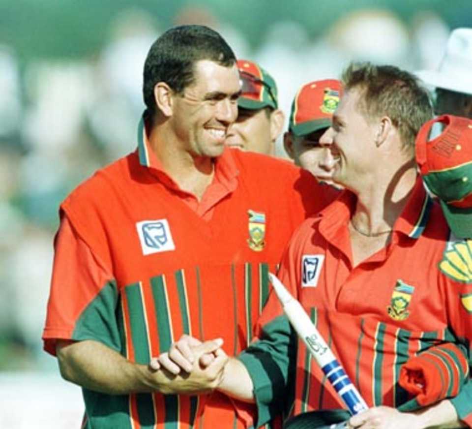 Well done !! Capt Cronje congratulates Klusener after the win.... South Africa v NZ at Bellerive Oval, Hobart, Tasmania, Thursday December 11th 1997.