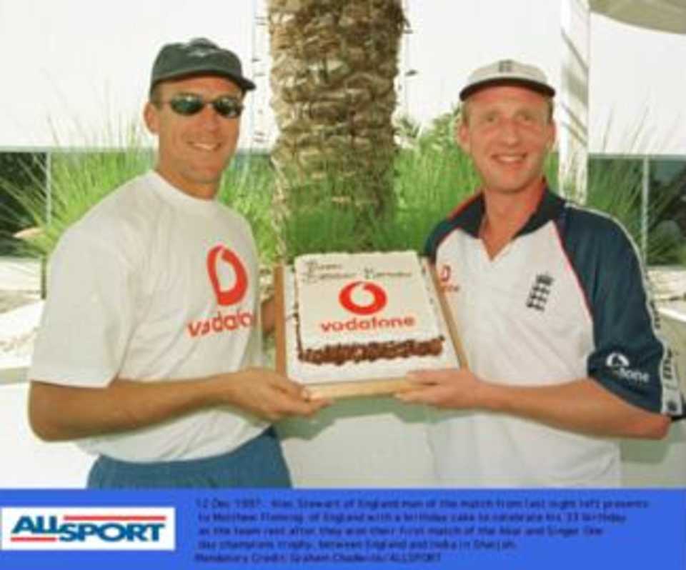 Alec Stewart (man of the match) helps Matthew Fleming (who took four wickets) celebrate his birthday and also England's seven run win over India in the opening match of the Champions Trophy in Sharjah.