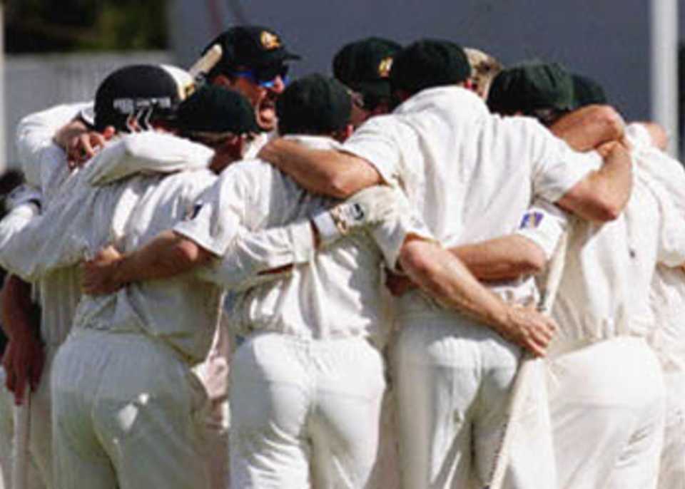 The Australians huddle, Rugby style, after beating the West Indies