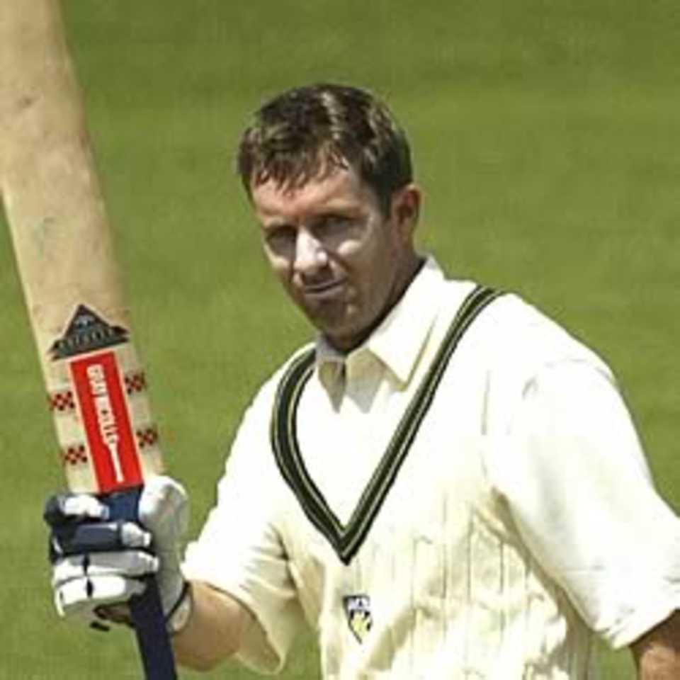 HOBART- NOVEMBER 15: Martin Love of Australia A celebrates his century during day one of the tour match between Australia A and England played at Bellerive Oval in Hobart, Australia, on November 15, 2002.