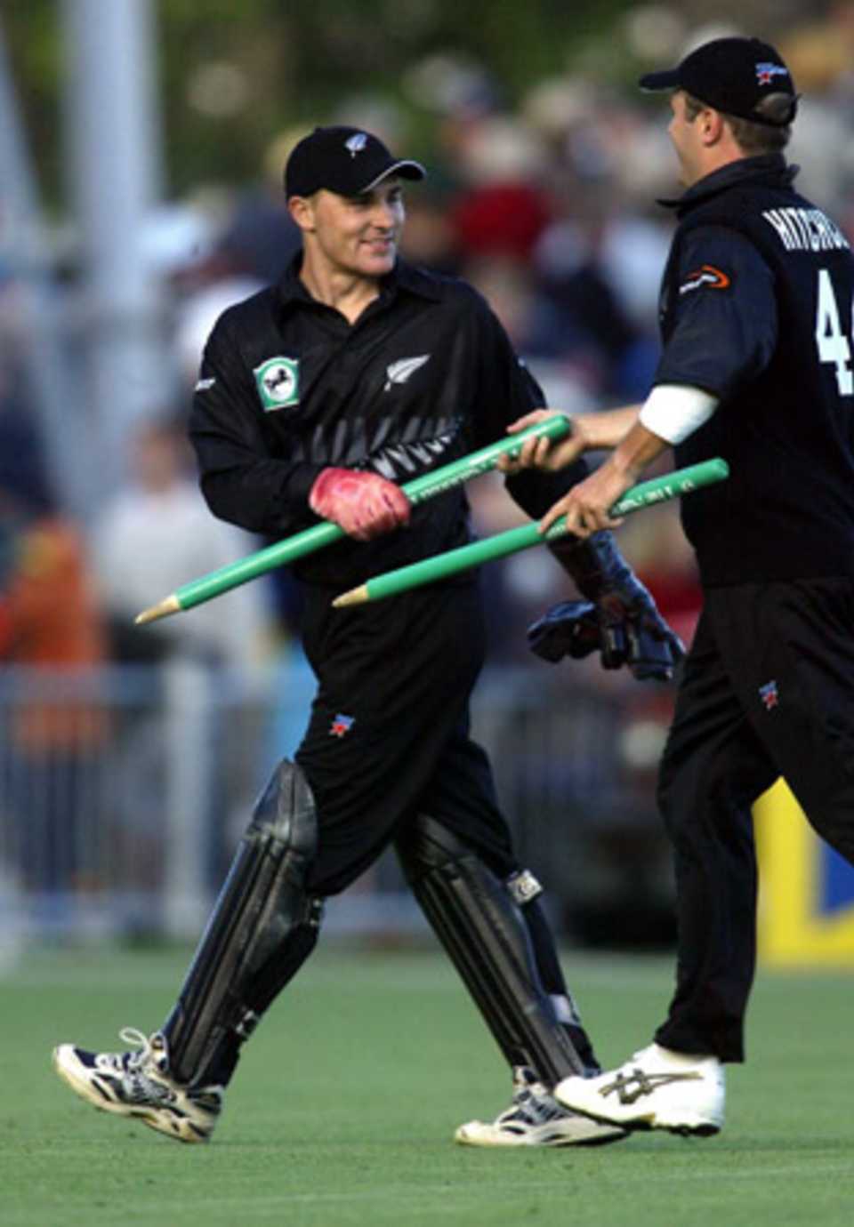 New Zealand player Paul Hitchcock (right) hands wicket-keeper Brendon McCullum a stump as they leave the field after winning the match. 2nd ODI: New Zealand v India at McLean Park, Napier, 29 December 2002.