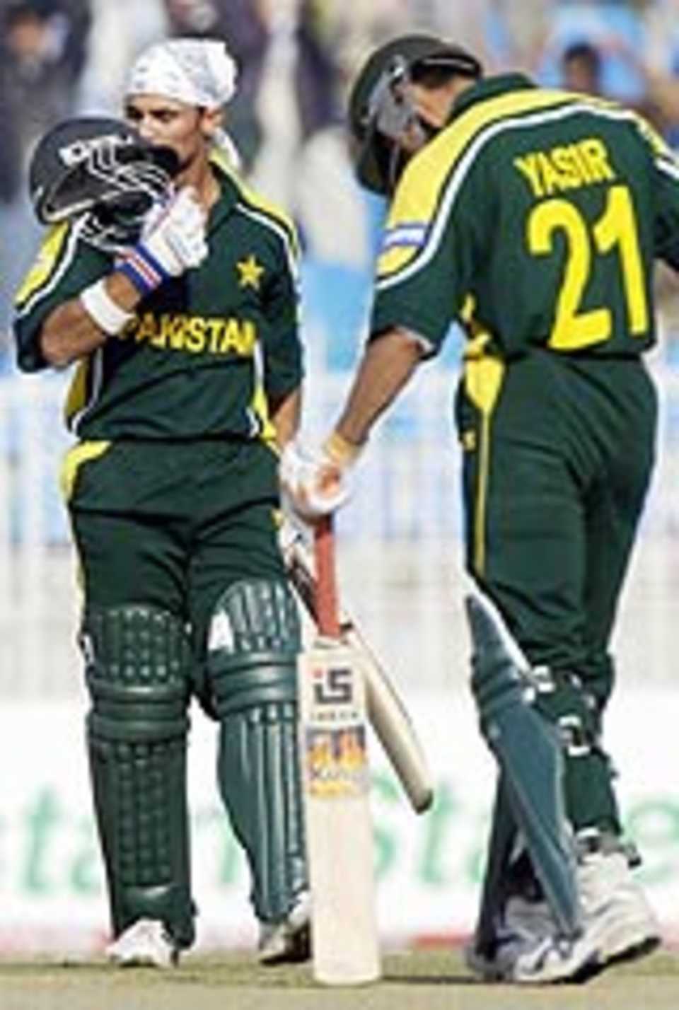 Imran Farhat kisses his helmet after getting his hundred against New Zealand, Pakistan v New Zealand, 5th ODI, Rawalpindi, December 7, 2003