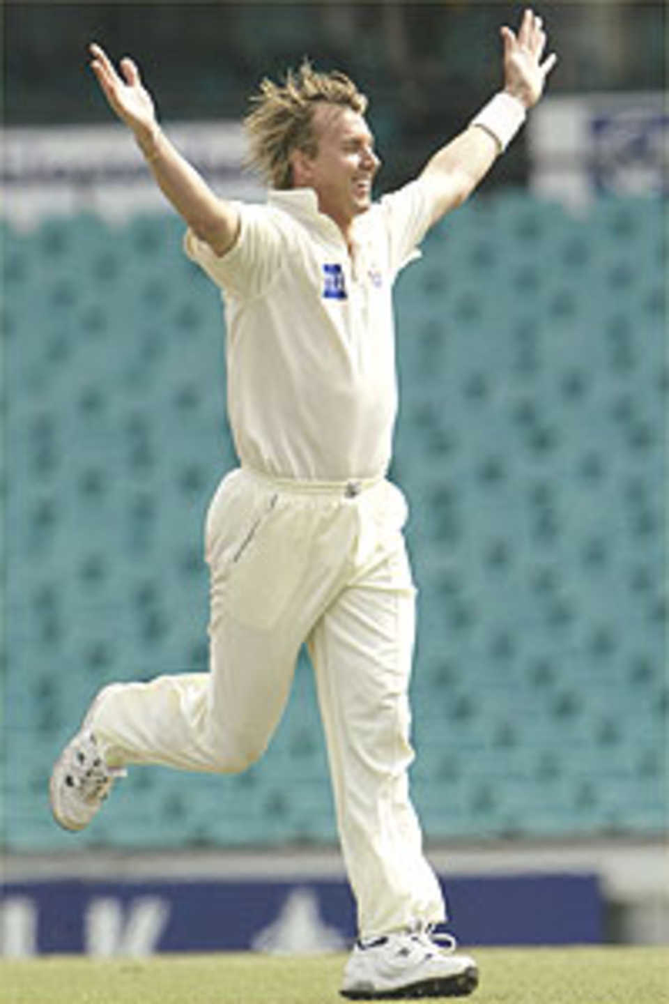 Brett Lee of the Blues celebrates after taking the wicket of Jamie Cox of the Tigers during play on day three of the Pura Cup cricket match between the NSW Blues and Tasmanian Tigers at the SCG December 21, 2003 in Sydney, Australia