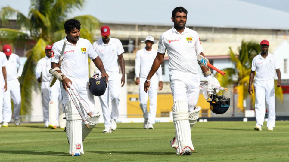 Kusal Perera and Dilruwan Perera troop off the field after steering Sri Lanka to victory, West Indies v Sri Lanka, 3rd Test, Barbados, 5th day, June 26, 2018