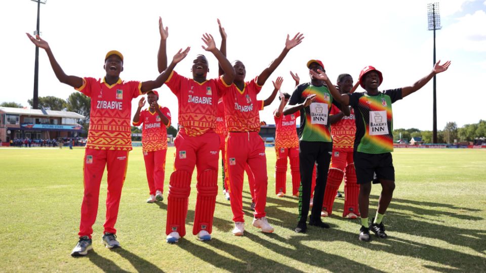 The Zimbabwe players celebrate in front of their supporters