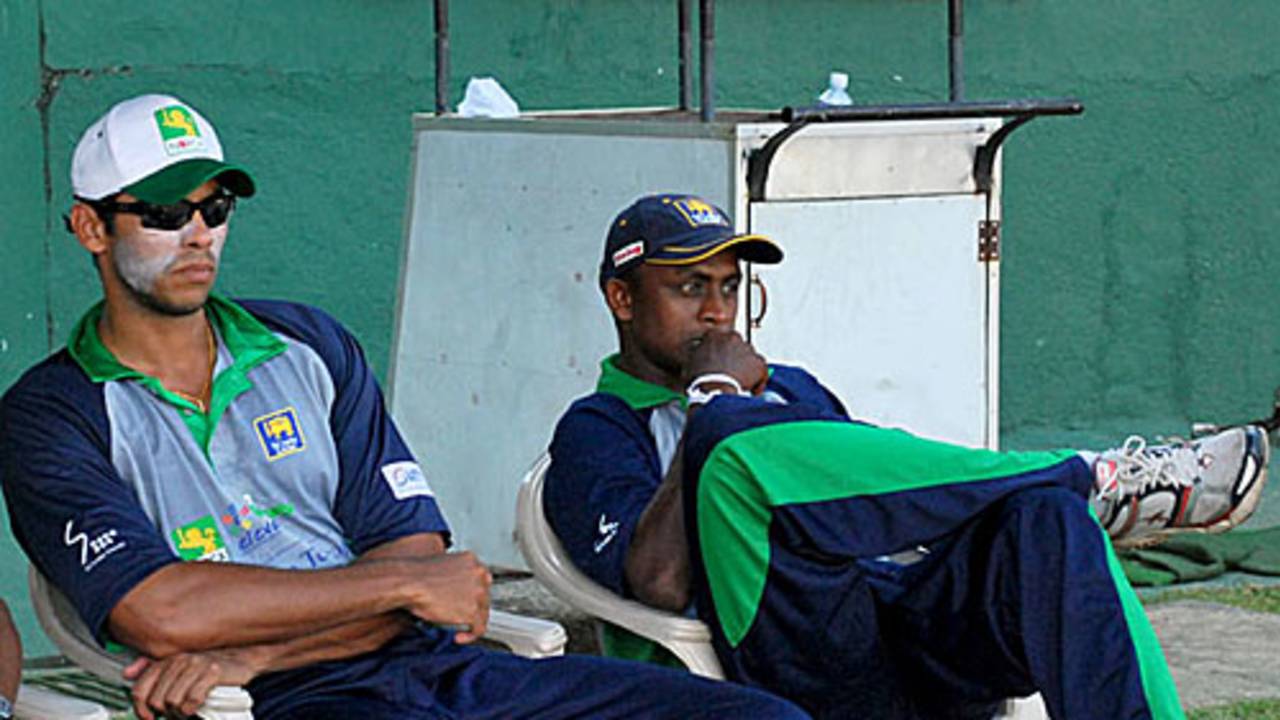 Michael Vandort and Ajantha Mendis watch a game in progress