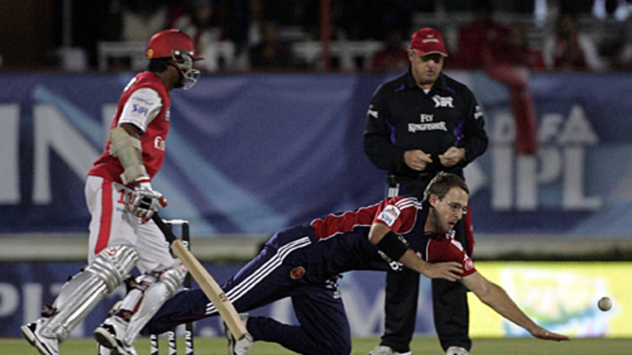 Daniel Vettori fields off his own bowling as Kumar Sangakkara looks on
