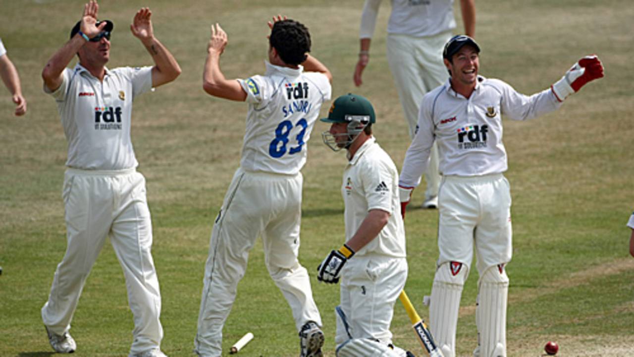 Pepler Sandri is congratulated on the wicket of Phil Hughes