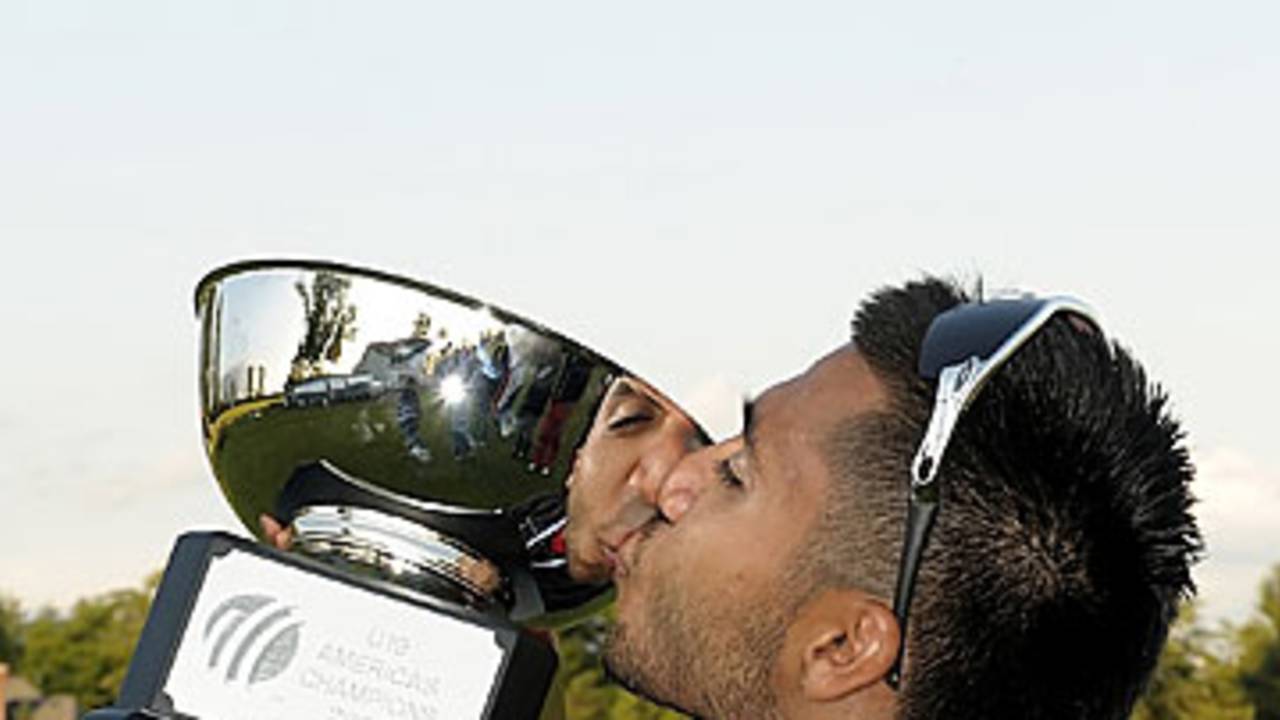 Arsalan Qadir of Canada kisses the trophy