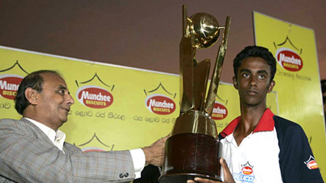 Dinal Dambarage with the winners' trophy