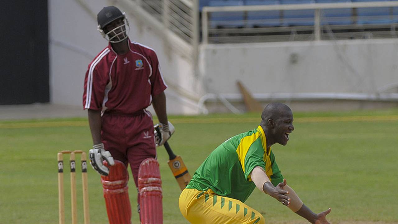 Darren Sammy dismisses Gavin Williams, one of his four victims, for a duck
