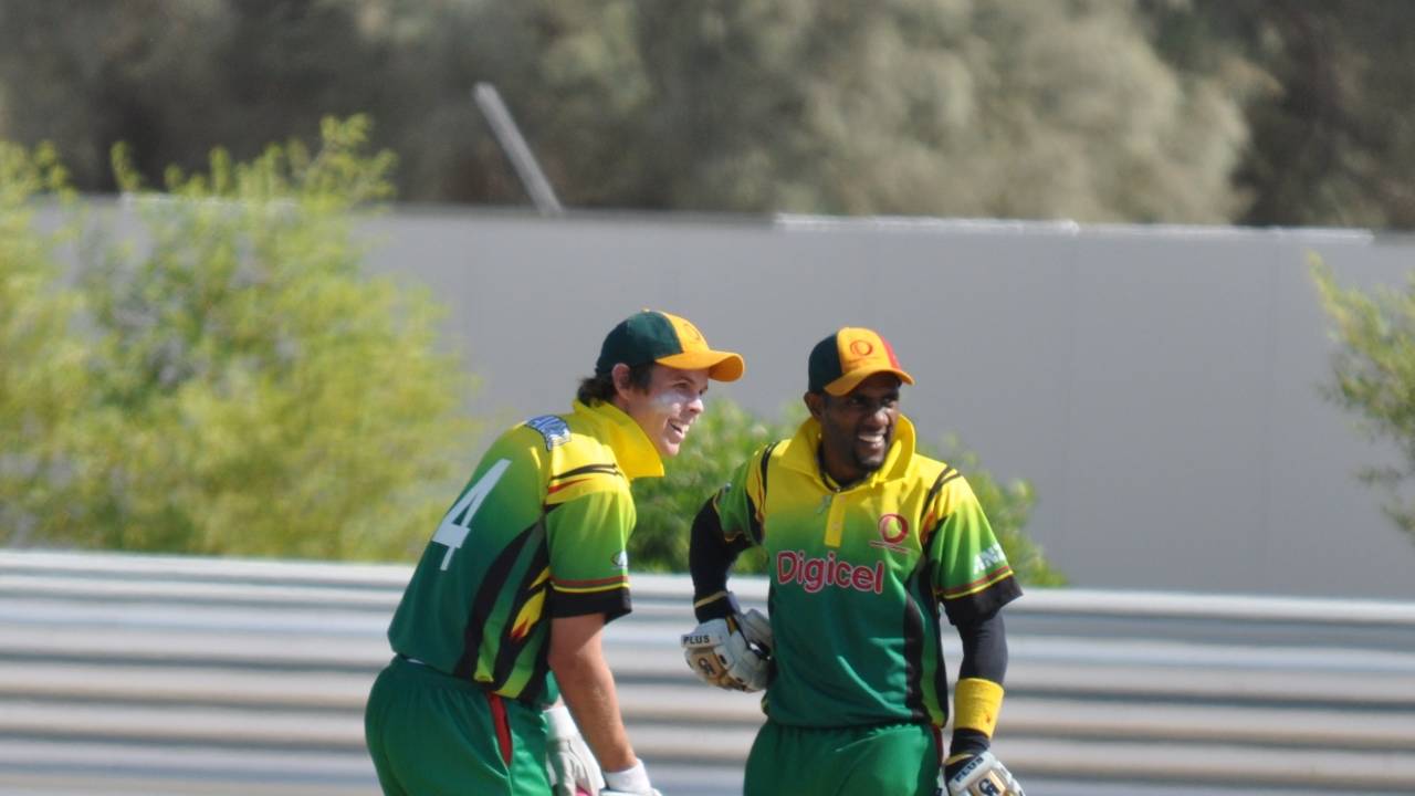 Captain Andrew Mansale (right) shares a joke with Jonathon Dunn after hitting another six