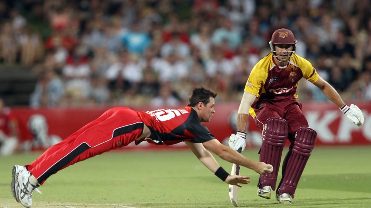 Daniel Christian dives to field one off his own bowling