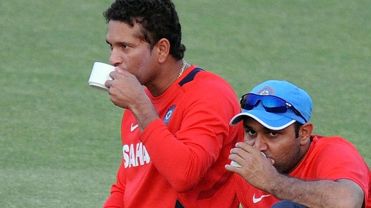 Sachin Tendulkar and Virender Sehwag sip some tea during a break from training, Mohali, March 27, 2010