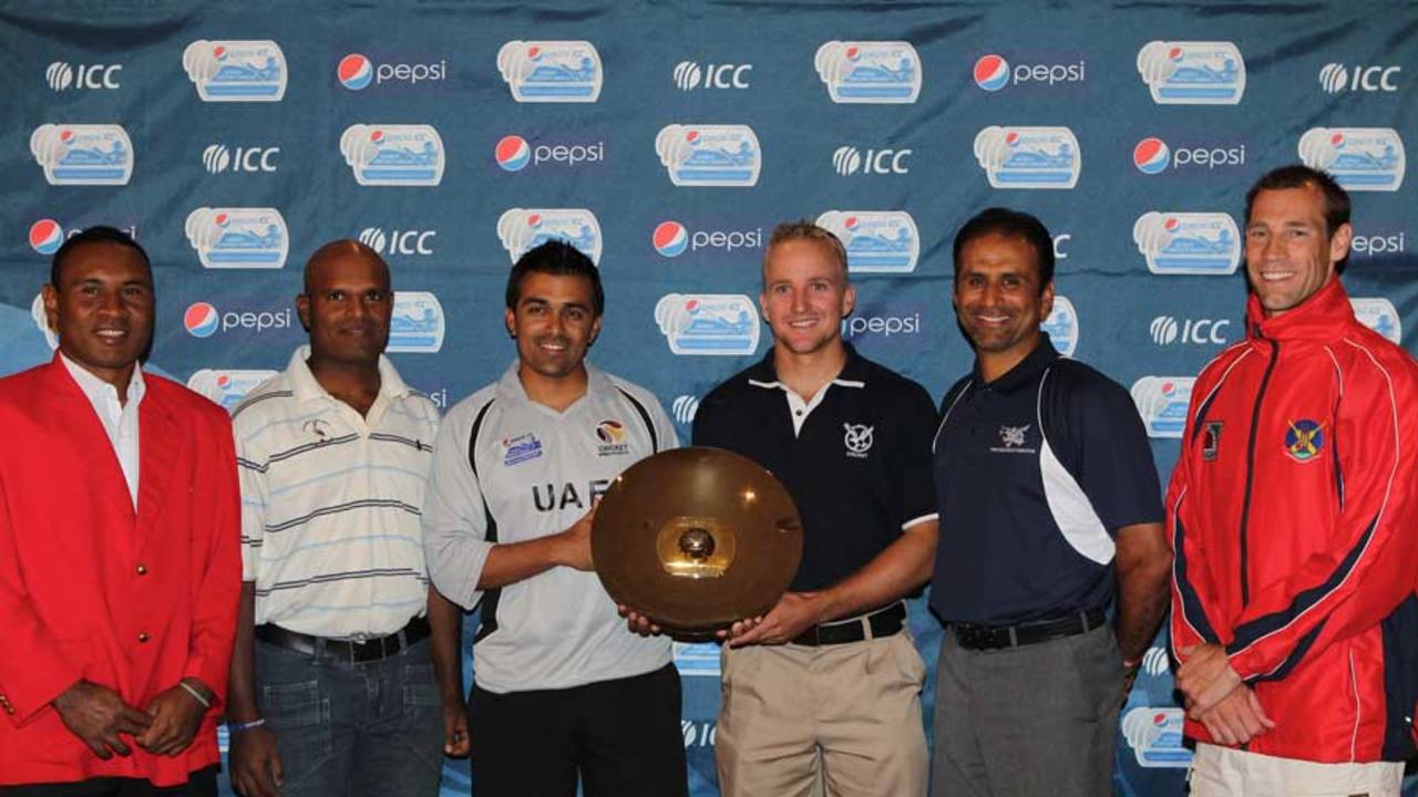 The captains of the teams participating in the WCL Division 2 pose with the trophy