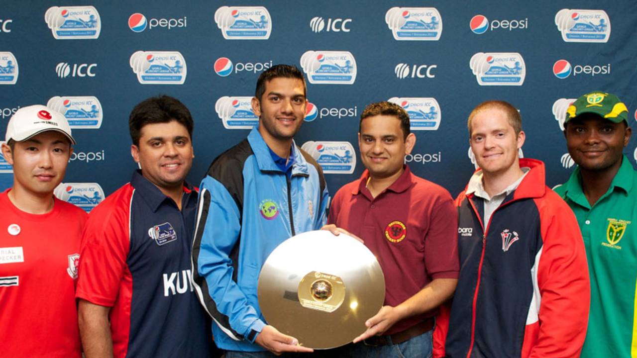 The captains of the six participating teams with the World Cricket League Division 7 trophy