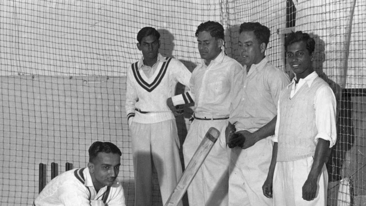 Vijay Merchant bats in the indoor nets of the Alan Fairfax Cricket School as his team-mates look on