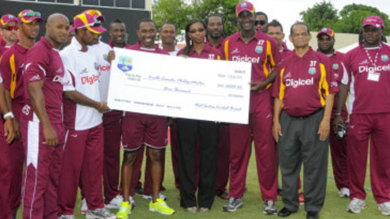 The West Indies team hand over a cheque to Runako Morton's widow, West Indies v New Zealand, 3rd ODI, Basseterre, July 11, 2012